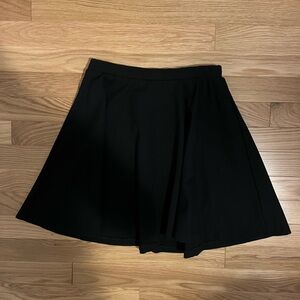 Black pleated mini skirt